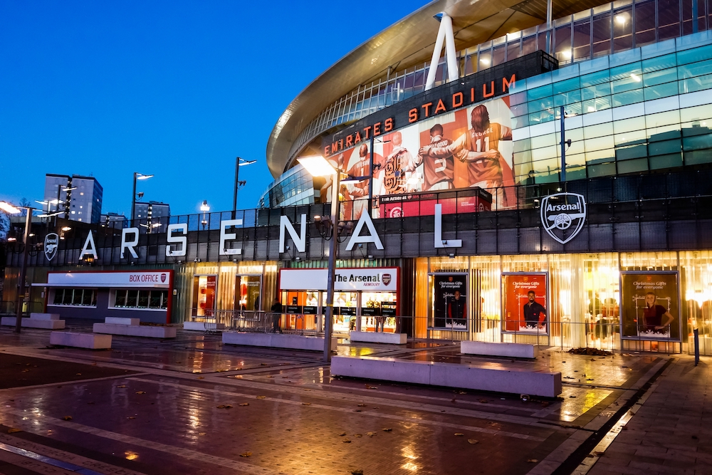 London, UK - Nov 2016: Exterior of Emirates Stadium at night with the Armoury and large mural.